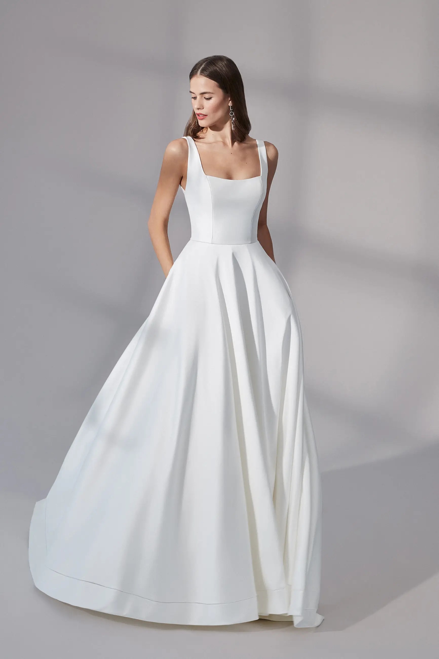 Model wearing a gown by Justin Alexander Signature