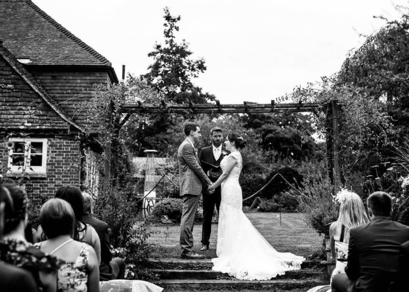 Сouple wearing a white gown and a gray suit